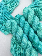 Turquoise yarn skeins on a light background
